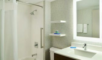 Private guest bathroom with shower and tub at Holiday Inn Express Toronto Downtown.