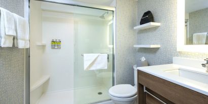 Guest bathroom with shower and free toiletries at Holiday Inn Express Toronto Downtown.