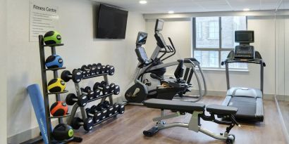 Fully equipped fitness center at Holiday Inn Express Toronto Downtown.