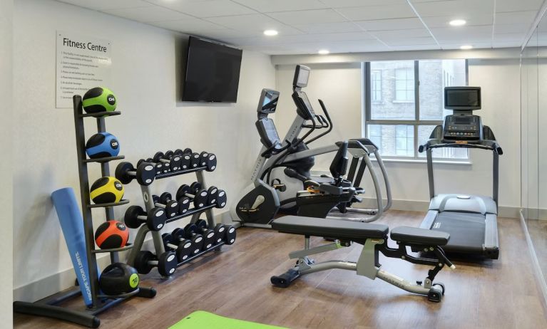 Fully equipped fitness center at Holiday Inn Express Toronto Downtown.