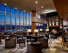 Hotel bar lounge area with fireplace at Fairmont Vancouver Airport - YVR Terminal Hotel.