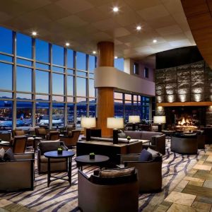 Hotel bar lounge area with fireplace at Fairmont Vancouver Airport - YVR Terminal Hotel.