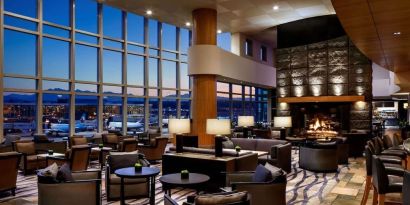 Hotel bar lounge area with fireplace at Fairmont Vancouver Airport - YVR Terminal Hotel.