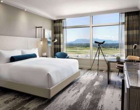 Day use room with large window, sofa, work desk and private bathroom at Fairmont Vancouver Airport - YVR Terminal Hotel.