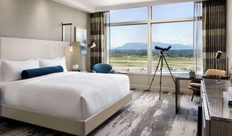 Day use room with large window, sofa, work desk and private bathroom at Fairmont Vancouver Airport - YVR Terminal Hotel.