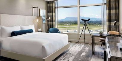 Day use room with large window, sofa, work desk and private bathroom at Fairmont Vancouver Airport - YVR Terminal Hotel.