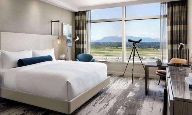 Day use room with large window, sofa, work desk and private bathroom at Fairmont Vancouver Airport - YVR Terminal Hotel.