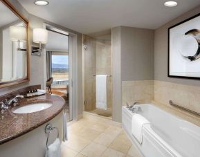 Private guest bathroom with shower and tub at Fairmont Vancouver Airport - YVR Terminal Hotel.