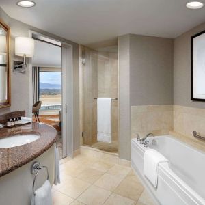 Private guest bathroom with shower and tub at Fairmont Vancouver Airport - YVR Terminal Hotel.