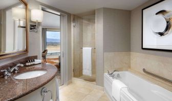 Private guest bathroom with shower and tub at Fairmont Vancouver Airport - YVR Terminal Hotel.