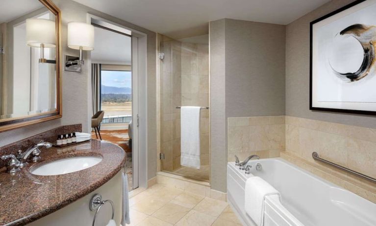 Private guest bathroom with shower and tub at Fairmont Vancouver Airport - YVR Terminal Hotel.