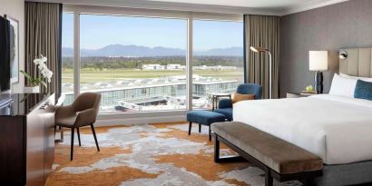 Bright and spacious day use room with TV, sofa, work desk and private bathroom at Fairmont Vancouver Airport - YVR Terminal Hotel.