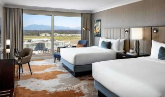 Bright and spacious day use twin room with TV, sofa, work desk and private bathroom at Fairmont Vancouver Airport - YVR Terminal Hotel.