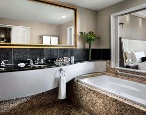 Guest bathroom with tub and free toiletries at Fairmont Vancouver Airport - YVR Terminal Hotel.