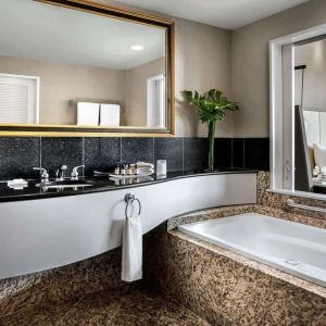 Guest bathroom with tub and free toiletries at Fairmont Vancouver Airport - YVR Terminal Hotel.