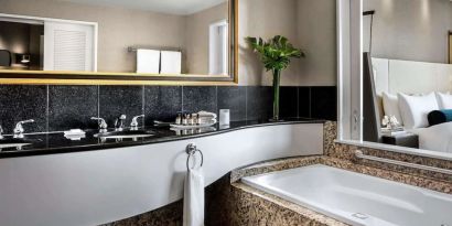 Guest bathroom with tub and free toiletries at Fairmont Vancouver Airport - YVR Terminal Hotel.