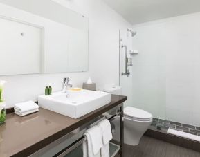 Guest bathroom with shower at YVE Hotel Miami.