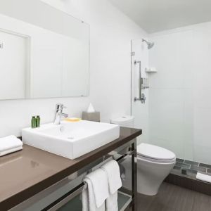 Guest bathroom with shower at YVE Hotel Miami.