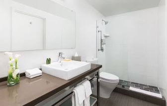 Guest bathroom with shower at YVE Hotel Miami.