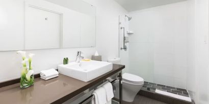 Guest bathroom with shower at YVE Hotel Miami.