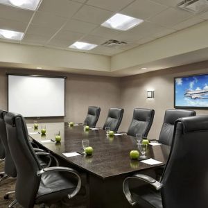 Professional meeting room with ergonomic chairs at Acclaim Hotel Calgary Airport.