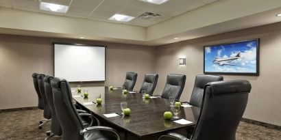 Professional meeting room with ergonomic chairs at Acclaim Hotel Calgary Airport.