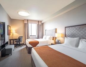 Day use twin room with work desk and private bathroom at Acclaim Hotel Calgary Airport.