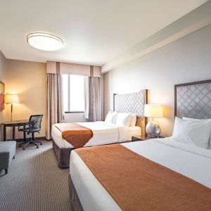 Day use twin room with work desk and private bathroom at Acclaim Hotel Calgary Airport.