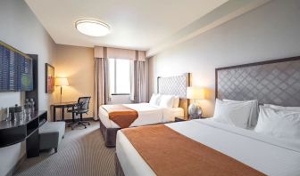 Day use twin room with work desk and private bathroom at Acclaim Hotel Calgary Airport.