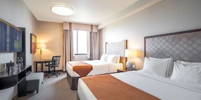 Day use twin room with work desk and private bathroom at Acclaim Hotel Calgary Airport.