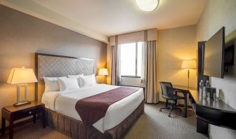 Standard day use room with TV, work desk and private bathroom at Acclaim Hotel Calgary Airport.