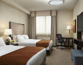 Day use twin room with TV and work desk at Acclaim Hotel Calgary Airport.