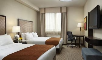 Day use twin room with TV and work desk at Acclaim Hotel Calgary Airport.