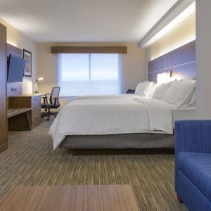 Day use room with TV, work desk, living area and private bathroom at Holiday Inn Express & Suites North Bay.