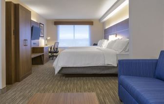 Day use room with TV, work desk, living area and private bathroom at Holiday Inn Express & Suites North Bay.