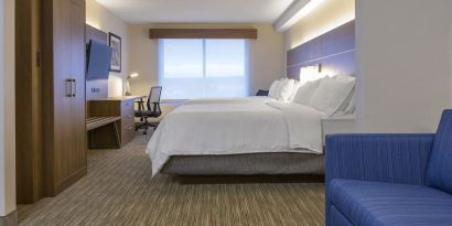 Day use room with TV, work desk, living area and private bathroom at Holiday Inn Express & Suites North Bay.