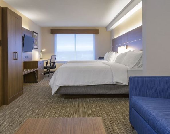 Day use room with TV, work desk, living area and private bathroom at Holiday Inn Express & Suites North Bay.