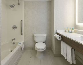 Guest bathroom with tub and shower at Holiday Inn Express & Suites North Bay.