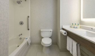 Guest bathroom with tub and shower at Holiday Inn Express & Suites North Bay.