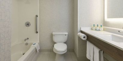 Guest bathroom with tub and shower at Holiday Inn Express & Suites North Bay.