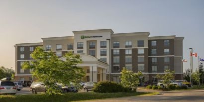 Hotel exterior with parking area at Holiday Inn Express & Suites North Bay.