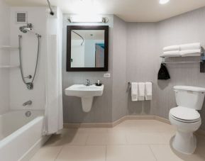 Guest bathroom with shower and tub at Courtyard By Marriott Los Angeles LAX/Century Boulevard.