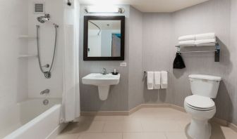 Guest bathroom with shower and tub at Courtyard By Marriott Los Angeles LAX/Century Boulevard.