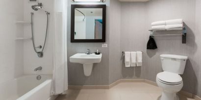 Guest bathroom with shower and tub at Courtyard By Marriott Los Angeles LAX/Century Boulevard.