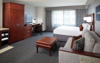 Day use room with sofa and work desk at Courtyard By Marriott Los Angeles LAX/Century Boulevard.