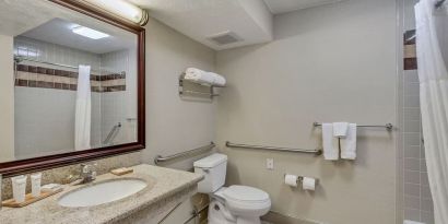 Guest bathroom with shower and tub at Radisson Hotel Salt Lake City Airport.