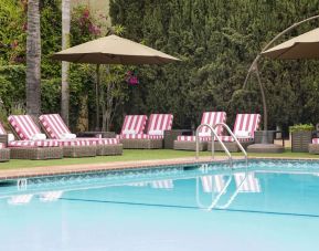 Sun loungers beside pool at Hollywood Hotel.