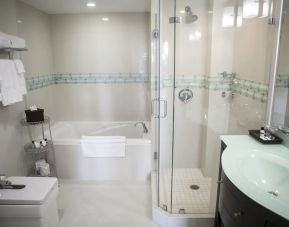 Guest bathroom with shower and tub at The Mutiny Hotel.