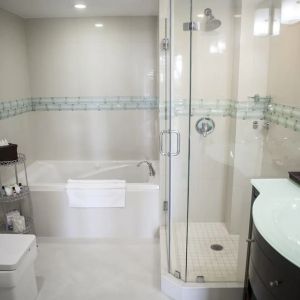 Guest bathroom with shower and tub at The Mutiny Hotel.