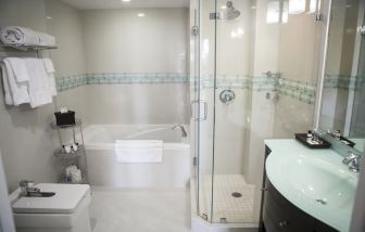 Guest bathroom with shower and tub at The Mutiny Hotel.